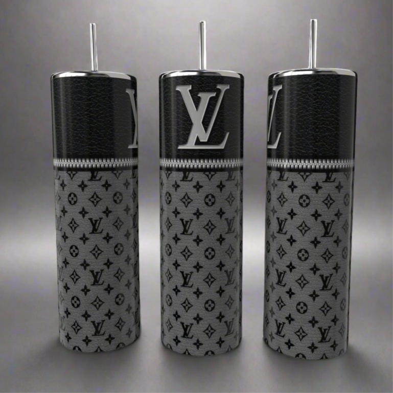 Three Louis V 20oz Skinny Tumblers by Kreative Kreationz, featuring a sleek black upper texture with gray "LV" logo patterns, elegantly stand on a reflective gray surface. These eco-friendly luxury cylindrical bottles with straws blend style and sustainability seamlessly.