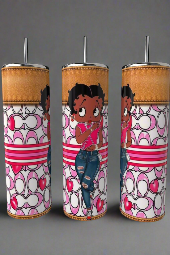 The Kreative Kreationz Betty B Coach 20oz Skinny Tumblers are adorned with Betty Boop in red tops and jeans against heart and loop patterns in red, pink, and white. Each tumbler includes a metal straw and an amber-colored lid.