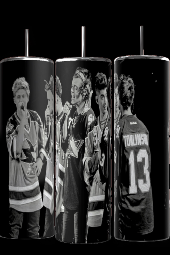 The Kreative Kreationz One Direction B&W 20oz Stainless Steel Tumbler offers a sleek black-and-white design depicting a group of people in hockey jerseys. Two individuals are holding microphones, and one proudly displays 