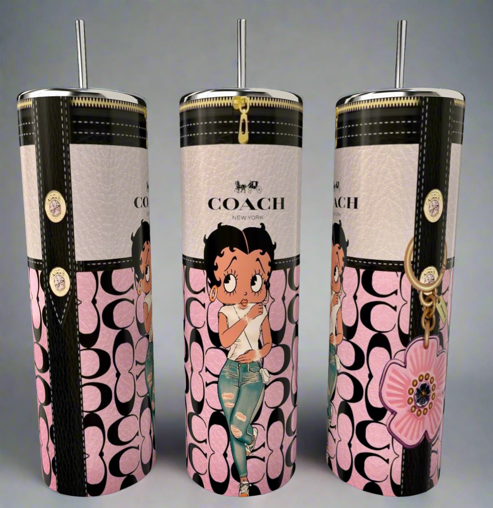 The Kreative Kreationz Betty B 20oz Skinny Tumbler features a floral design, metallic lid and straw, Coach-style pink and black logo, and a cartoon girl in ripped jeans—perfect for eco-friendly sipping in style!.