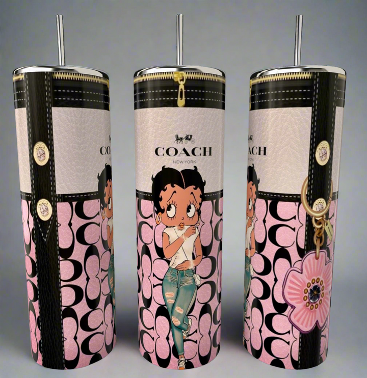 The Kreative Kreationz Betty B 20oz Skinny Tumbler features a floral design, metallic lid and straw, Coach-style pink and black logo, and a cartoon girl in ripped jeans—perfect for eco-friendly sipping in style!.