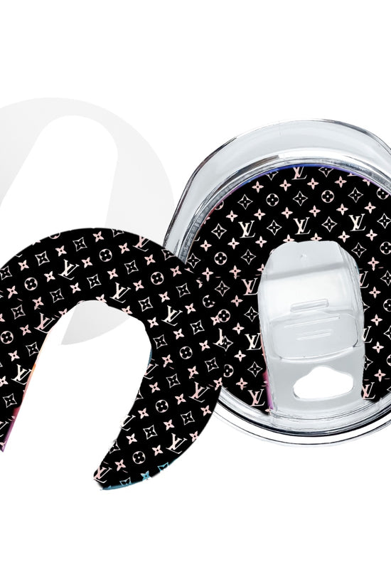 The Kreative Kreationz 20oz Tumbler Topper is a reusable, clear lid with a removable black crescent-shaped topper featuring multicolored LV-inspired monogram logos, ideal for skinny tumblers and compatible with sublimatable aluminum toppers.