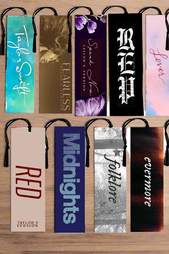 Ten Taylor Swift Eras Bookmarks by Kreative Kreationz, arranged in two rows on a wooden surface. 