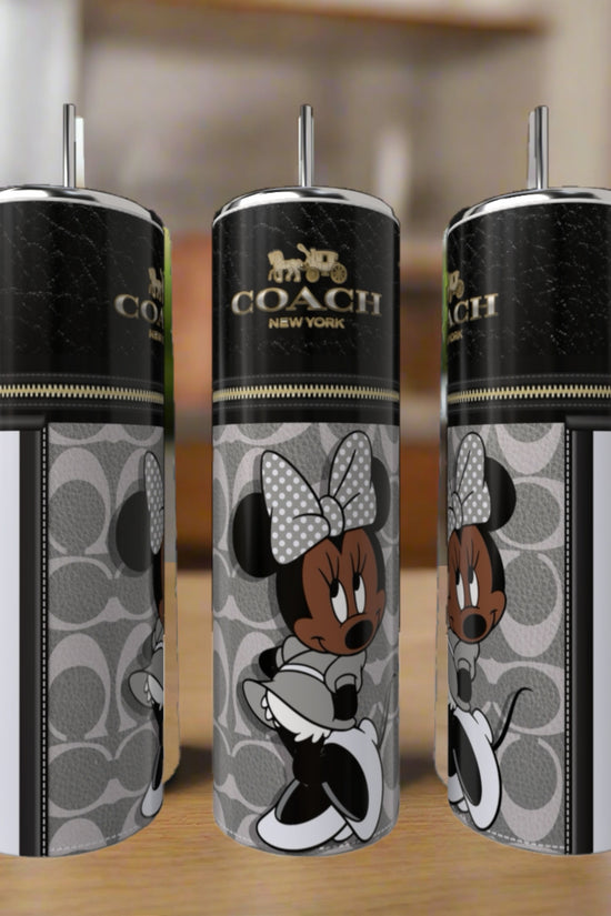 Three Kreative Kreationz Minnie Mouse Coach Series 20oz Skinny Tumblers, each with silver straws, showcase a Coach New York logo and stylish Minnie Mouse on a gray pattern, displayed indoors on a wooden surface.