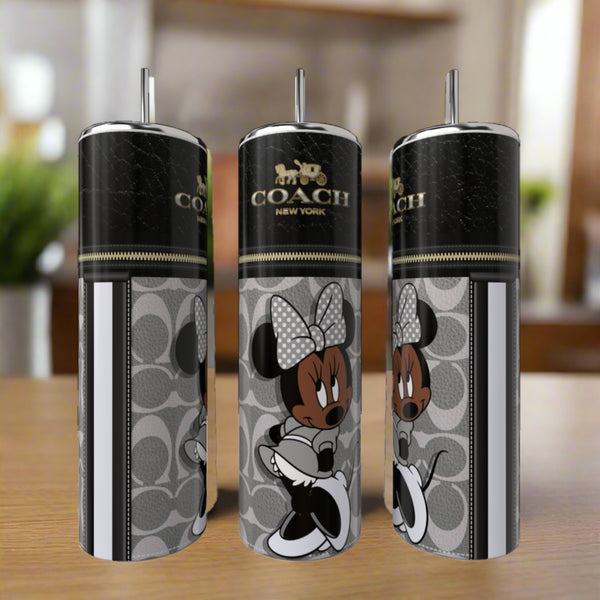 Three Kreative Kreationz Minnie Mouse Coach Series 20oz Skinny Tumblers, each with silver straws, showcase a Coach New York logo and stylish Minnie Mouse on a gray pattern, displayed indoors on a wooden surface.