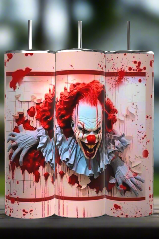A set of three 20 oz tumblers from the Kreative Kreationz IT Halloween Series features a menacing clown with red hair and face paint, emerging through a blood-spattered background. The design shows the clown tearing through a white textured surface, enhancing the horror theme. Each tumbler includes a spill-proof lid.