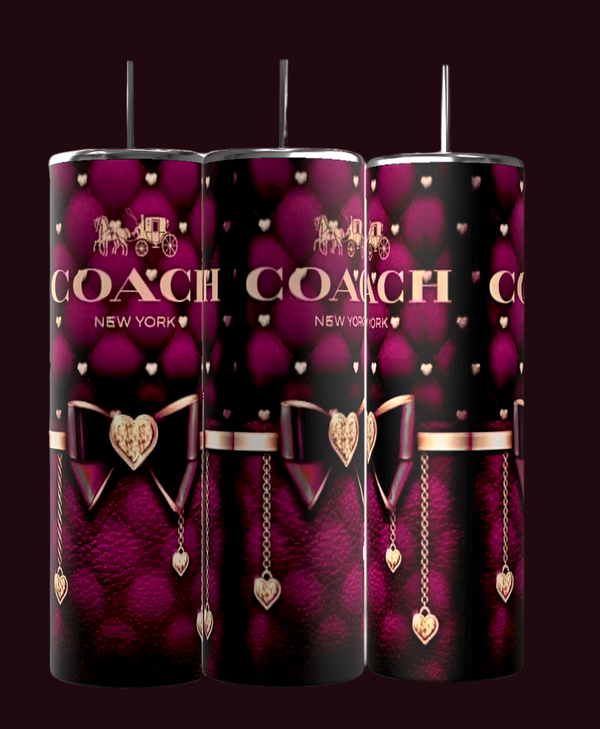 The Coach Wine 20oz Tumblers by Kreative Kreationz are eco-friendly and feature a stylish dark purple and black design with gold chains, heart charms, and bows. "COACH" and the carriage logo in gold elegantly top each stainless steel tumbler.