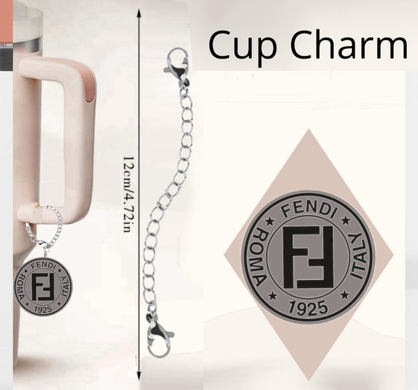 The Fendi Charm Dangle from Kreative Kreationz drapes elegantly from a handle, featuring "Fendi," "Roma," "Italy," and "1925" text with a central "F" logo. This durable, waterproof cup accessory includes unique designs and a 12 cm chain.