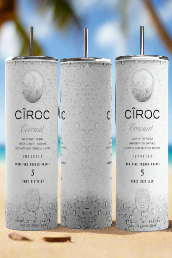 Two cans of Kreative Kreationz Ciroc 20oz Tumbler with 3D Lid Topper are shown on a wooden surface, reminiscent of travel tumblers. The left can is Red Berry flavor, topped with ice and a cherry. The right can is Vodka Snap Frost flavor, topped with ice and a lemon slice. Both cans feature product information and branding.