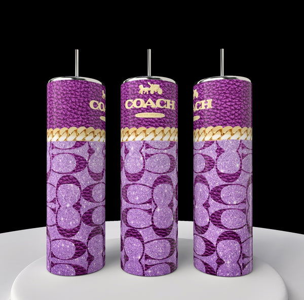 Three tall Kreative Kreationz Coach 20oz Skinny Tumblers featuring purple Coach logo patterns, gold accents, and metallic straws are showcased on a white surface with a black background, exemplifying chic luxury drinkware.