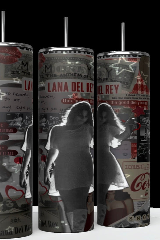 The Lana Del Ray Glow 20oz Tumblers from Kreative Kreationz are tall, cylindrical mugs adorned with a collage of various images and text related to the artist. Prominent elements include pictures of Lana, song titles, and retro icons like Coca-Cola logos, overlaid with stars and hearts. These tumblers are designed to keep beverages hot or cold.