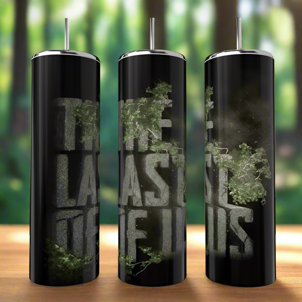 Three tall, black "The Last Of Us Fans" 20oz Skinny Tumblers by Kreative Kreationz, each with a metallic lid and straw, feature weathered mossy lettering amid a blurred forest backdrop. Eco-friendly and stylish design.
