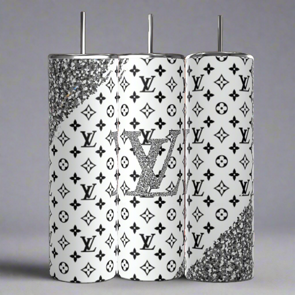 The Kreative Kreationz Louis Vuitton Black & Silver 20oz Tumbler set includes three luxury-inspired tumblers featuring a high-quality stainless steel finish, white background with black patterns, glittery silver accents, and a central tumbler displaying a sparkling logo reminiscent of a Louis Vuitton design.