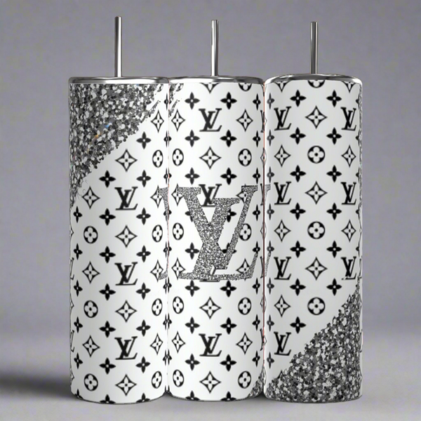The Kreative Kreationz Louis Vuitton Black & Silver 20oz Tumbler set includes three luxury-inspired tumblers featuring a high-quality stainless steel finish, white background with black patterns, glittery silver accents, and a central tumbler displaying a sparkling logo reminiscent of a Louis Vuitton design.