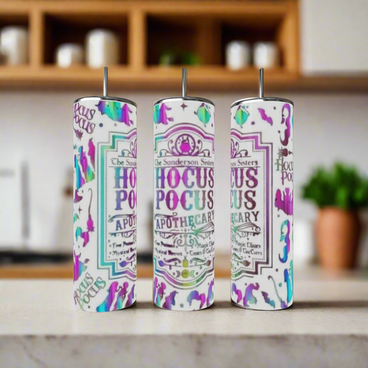Three vibrant Kreative Kreationz Hocus Pocus 20oz Tumblers with straws sit on a kitchen counter. Adorned with "Hocus Pocus Apothecary" text and fun designs, these eco-friendly tumblers bring charm to any kitchen setting.