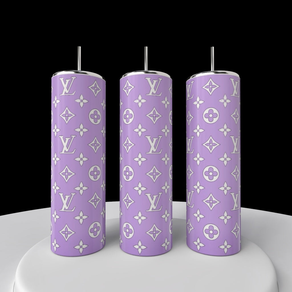 The LV Inspired 20oz Tumbler Collection by Kreative Kreationz features three tall stainless steel tumblers with metallic straws, a purple background, and white luxury monogram patterns, shown on a white surface against a black backdrop.