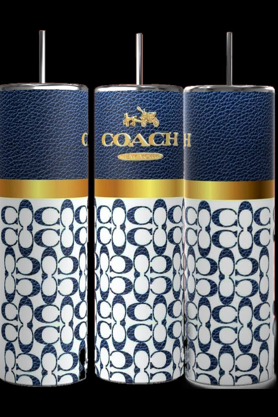 Three Coach-inspired dark blue 20oz tumblers from Kreative Kreationz, each accompanied by a metal straw, are displayed. These tumblers showcase a textured dark blue upper section featuring the 