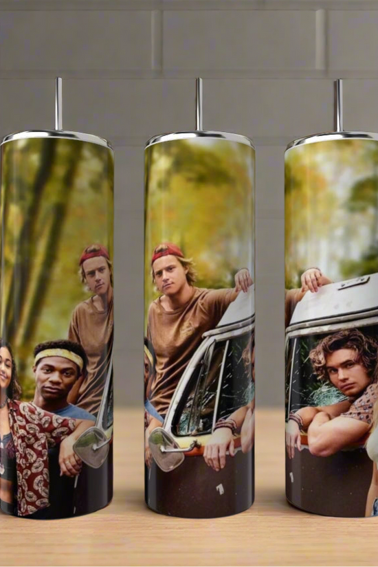 Three Pogues OBX 20oz Tumblers by Kreative Kreationz, each with a photo of four young adults by a vintage van in the woods, come with straws. They're shown on a kitchen counter with bottles and a plant in the background.