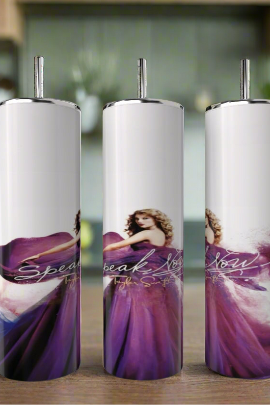 The Kreative Kreationz Speak Now Taylor’s Version 20oz Tumblers feature a woman in a flowing purple dress with curly hair, set against a blurred kitchen background and display “Speak Now” in elegant cursive for stylish, eco-friendly drinkware.
