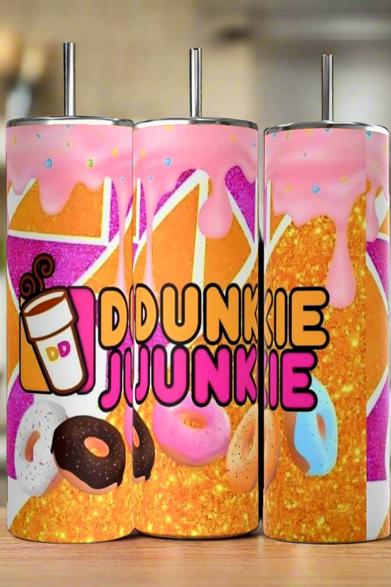 These Dunkin Junkie Drip 20oz Tumblers by Kreative Kreationz are vibrantly handmade and adorned with donut images and dripping pink frosting. The phrase 