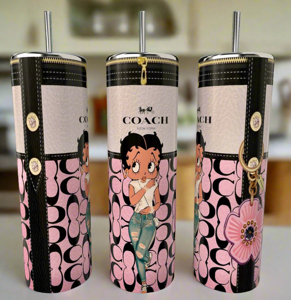 The Betty B Blush 20oz Skinny Tumbler by Kreative Kreationz features a cartoon woman in a pink top and distressed jeans, Coach New York logo, plus floral and zipper patterns in pink, black, and beige. A stylish reusable option!.