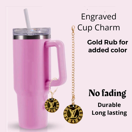 The Gold Laser Engraved LV Charm Dangle by Kreative Kreationz is an elegant gold-colored accessory for your pink tumbler, designed with a no-fade guarantee. Enjoy fast delivery and friendly service to ensure prompt satisfaction with your charming cup adornment.