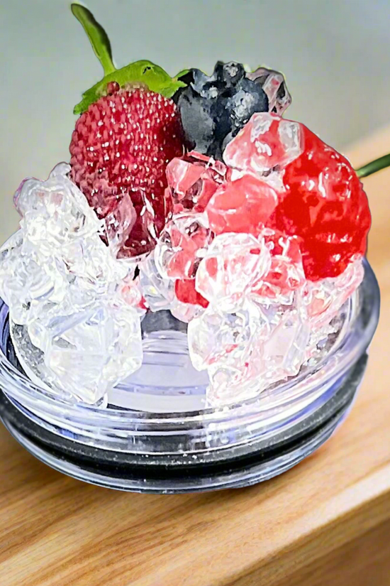 Four 3D Lid Toppers for a standard 20oz tumbler from Kreative Kreationz are displayed against a red background, each featuring different toppings: one with a lemon slice, one with a lime slice, one with a cherry, and one with crushed ice only. Text labels indicate the removable lids' toppings.