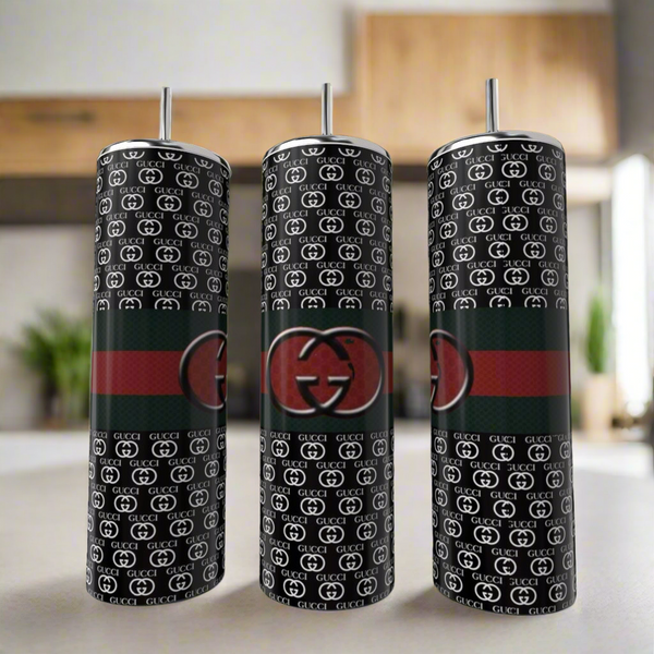 Three Gucci Dark 20oz Skinny Tumblers by Kreative Kreationz are shown. Each features a black base, repeating white “GG” pattern, a red and green stripe, and a large central “GG” logo, complete with metal straws.