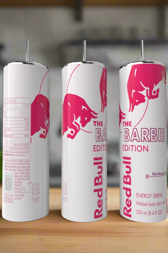 A Barbie Edition 20oz Tumbler by Kreative Kreationz sits on a wooden kitchen surface, featuring playful pink branding reminiscent of Barbie style, similar to the design found on Red Bull's Barbie Edition cans.