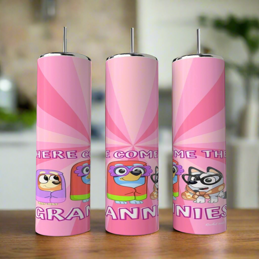 Three Bluey Grannies 20oz Stainless Steel Tumblers by Kreative Kreationz, featuring cartoon animals and "HERE COME THE GRANNIES" text, stand on a wooden surface—fun, eco-friendly drinkware for playful design fans.