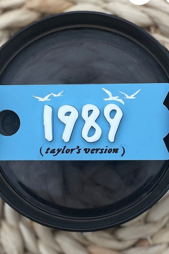 Stanley tumbler adorned with Sky Blue 'Taylor Swift 1989 Era Taylor’s Version' lid topper, a nostalgic and stylish accessory