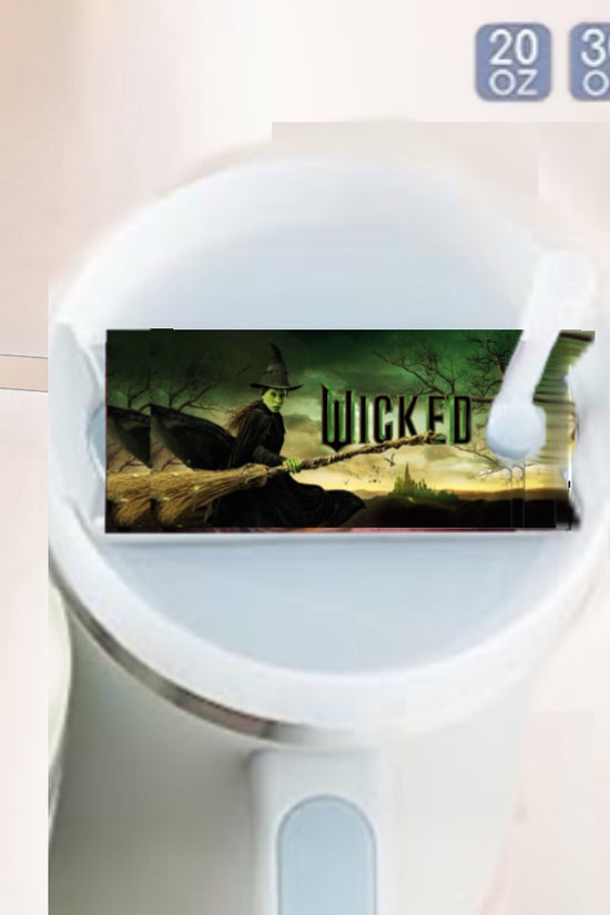 The Witch Stanley Lid Topper by Kreative Kreationz is a sublimated cylindrical mug with a handle, featuring a digital witch-on-broomstick label and 