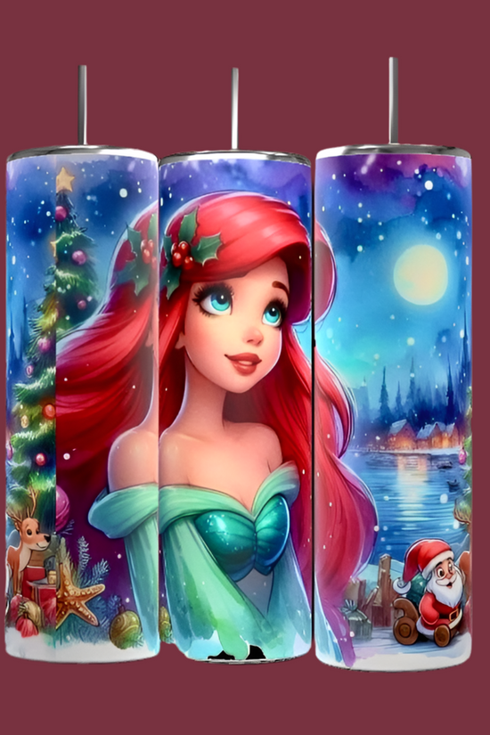 The Festive cylindrical lights resemble the Princess Ariel 20oz Tumbler by Kreative Kreationz, featuring an animated red-haired character in a green dress. The display captures the season's magic with cheer and creativity, as it is surrounded by a starry night, Christmas tree, reindeer, Santa Claus, and a snow-covered landscape.