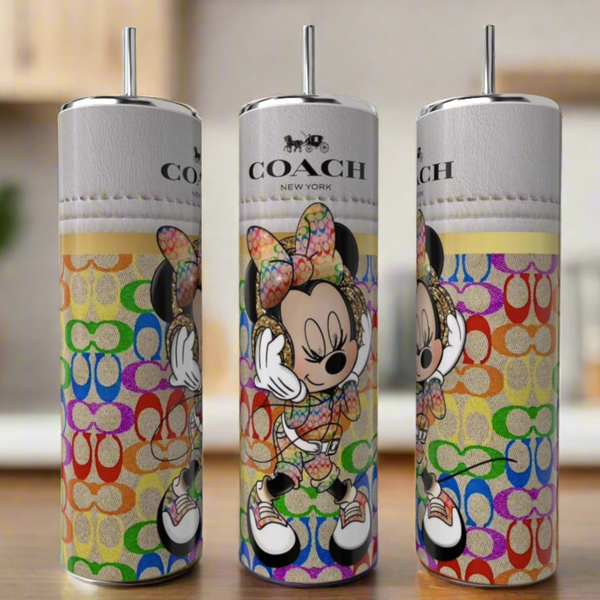 Three Minnie Mouse Coach 20oz Skinny Tumblers from Kreative Kreationz, featuring colorful logos and Minnie Mouse with a rainbow bow, are displayed on a kitchen counter for a chic luxury look.