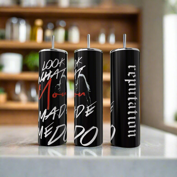 Three black 20oz "Look What You Made Me Do" skinny tumblers by Kreative Kreationz are shown on a counter, each with a silver straw, bold white and red text, plus a faint woman's side-profile graphic.