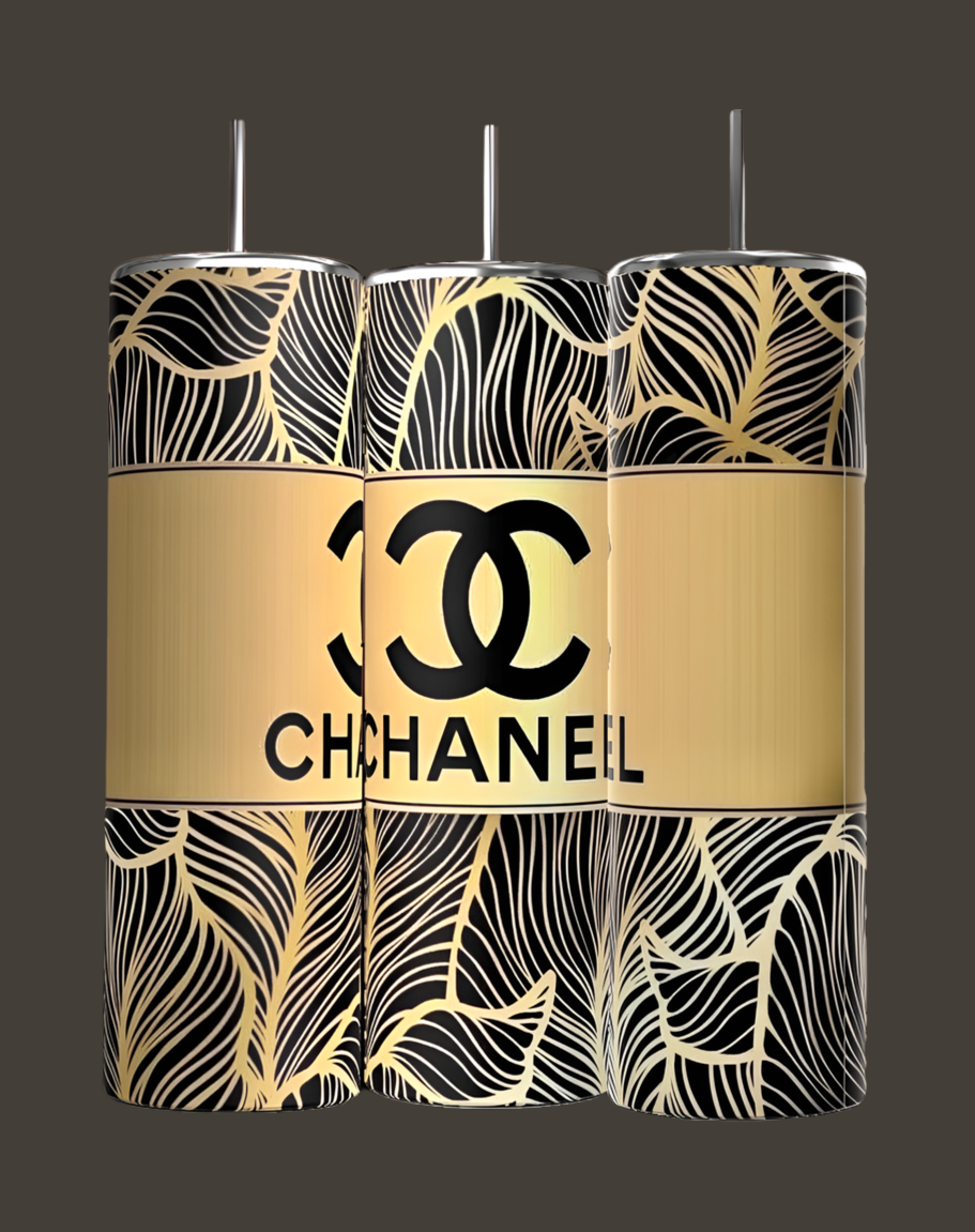 Three cylindrical, eco-friendly 20oz skinny tumblers from Kreative Kreationz feature a luxury-inspired black and gold leaf pattern and a bold gold stripe with the Chanel Skinny Tumbler logo in classic black.