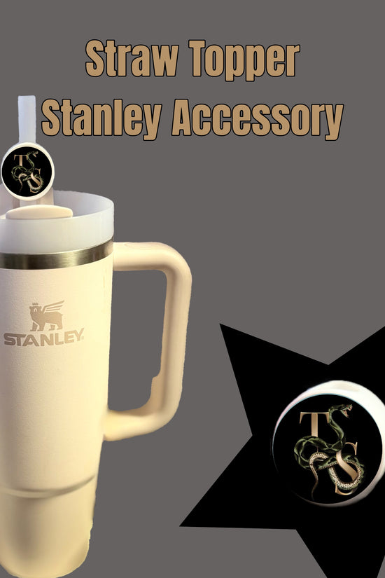 Beige Stanley cup with a handle and a round straw topper featuring a black background, letters, and dragon design. Reminiscent of the Kreative Kreationz Taylor Swift | REP Straw Topper. Text reads 