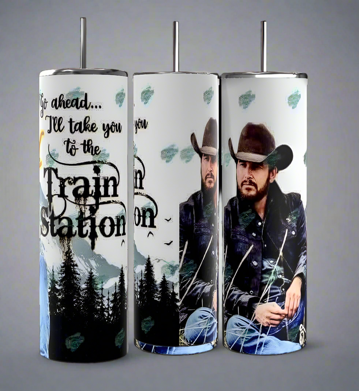 The Kreative Kreationz RIP Yellowstone 20oz Tumbler features a man in a cowboy hat, denim jacket, mountains, trees, and "Go ahead... I'll take you to the Train Station" for rustic, western-themed drinkware.