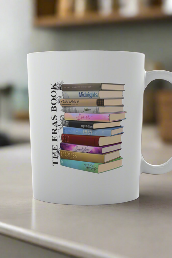 The Taylor Swift Eras Ceramic Mug by Kreative Kreationz features vibrant book stack designs titled 