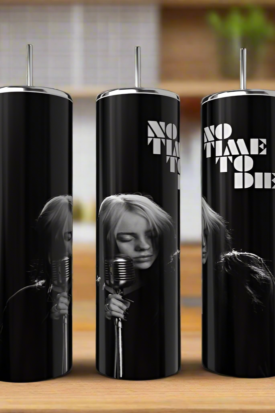 Three 20oz black stainless steel tumblers with silver lids and straws from Kreative Kreationz sit on a wooden surface, each featuring a monochrome Billie Eilish singing into a vintage microphone with 