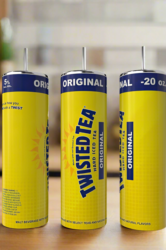 Three tall cans of Twisted Tea Original Hard Iced Tea sit on a wooden surface with a blurred kitchen background. Enjoy your drink with the eco-friendly Kreative Kreationz Twisted Tea 20oz Tumbler.