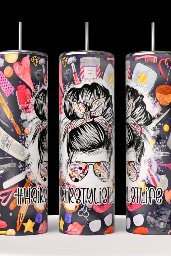 Kreative Kreationz's Hairstylist 20oz Tumblers feature vibrant designs with scissors, combs, hairdryers, and a styled woman's head. These black tumblers come with a spill-proof lid and splash pink, orange, and yellow hues alongside the 