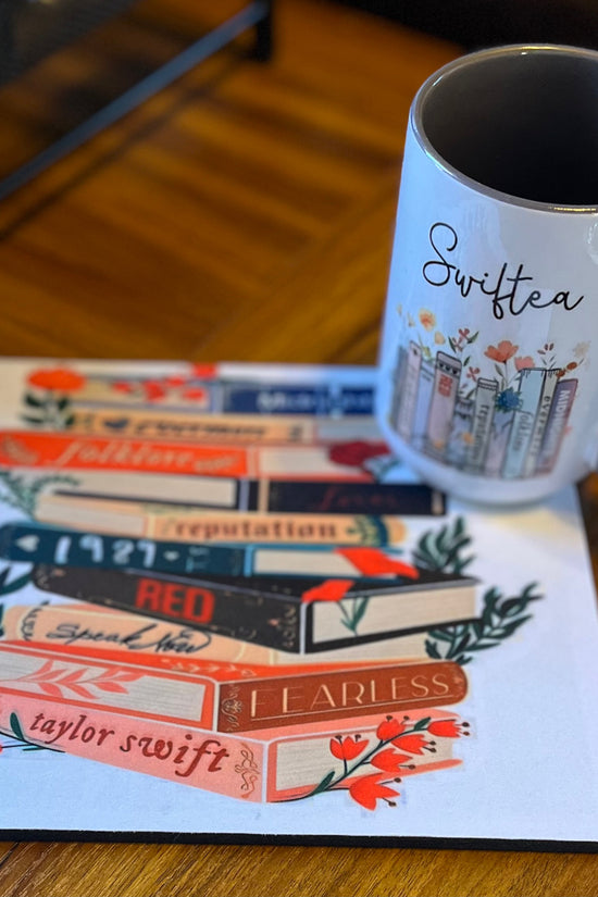 A charming Swiftea Gift Set by Kreative Kreationz sits on a table, featuring a white mug with the word 