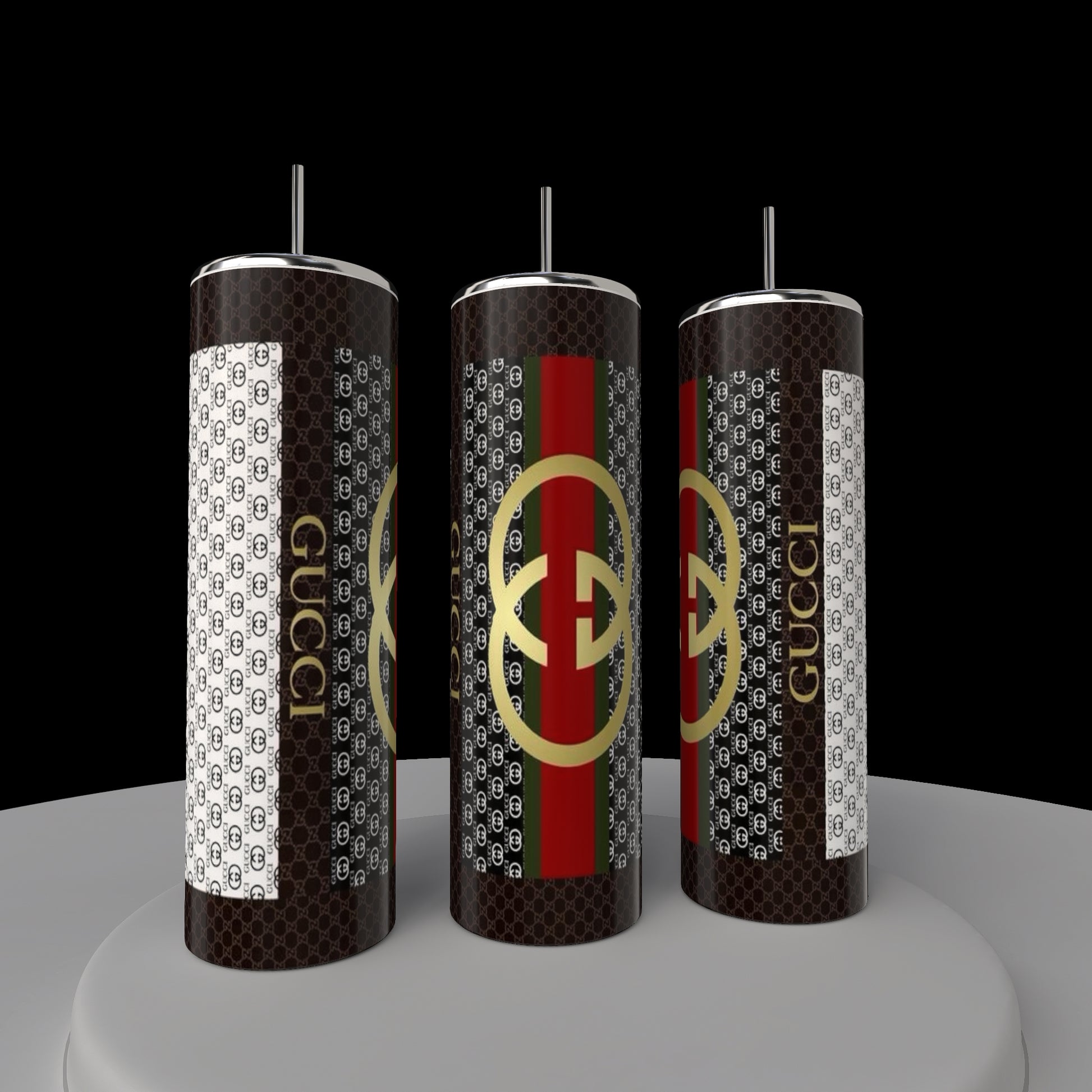 Three Gucci 20oz Tumblers by Kreative Kreationz sit on a round platform, featuring a black, white, red, and green pattern with overlapping letters. Made from high-quality stainless steel, these eco-friendly tumblers include straws and showcase a luxury-inspired design.