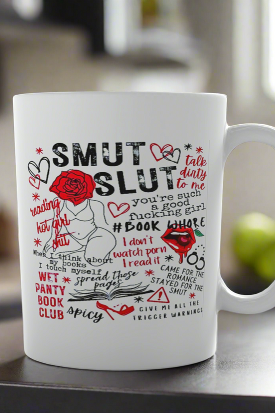 The Smut Ceramic Mug by Kreative Kreationz features bold text, hearts, roses, and flirty romance phrases—perfect for spicy book lovers. Conveniently dishwasher safe, it adds playful charm to your kitchen counter.