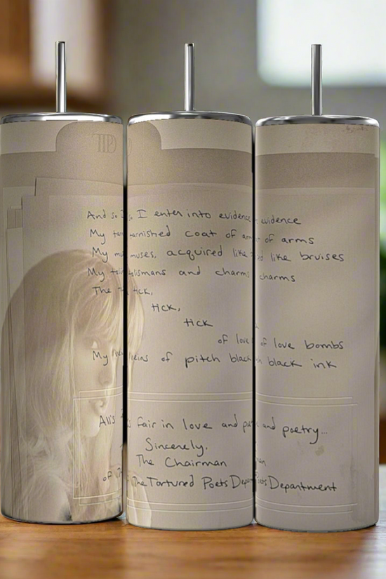 The Manuscript TTPD 20oz Tumblers by Kreative Kreationz feature handwritten poetry and a faded sketch on stainless steel, set side by side on wood with a blurred kitchen backdrop.