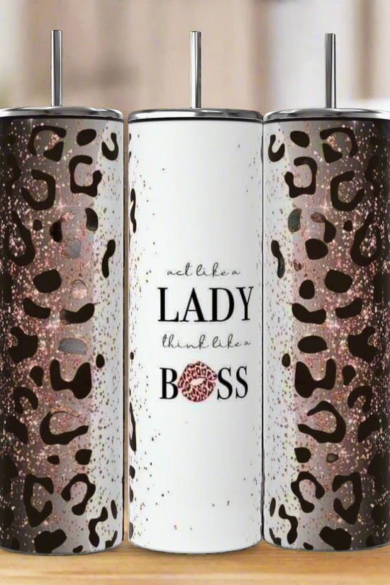 Three tall Kreative Kreationz Boss Lady 20oz Tumblers with metal straws; two have glitter leopard print, while the center features “act like a LADY think like a BOSS” in white with pink glitter on 