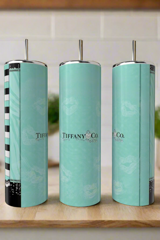 Three tall teal Kreative Kreationz Tiffany 20oz Tumblers with silver lids and straws are displayed on a wooden kitchen surface—an eco-friendly, stylish sipping option.