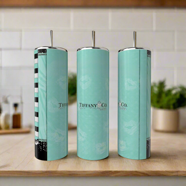 Three tall teal Kreative Kreationz Tiffany 20oz Tumblers with silver lids and straws are displayed on a wooden kitchen surface—an eco-friendly, stylish sipping option.