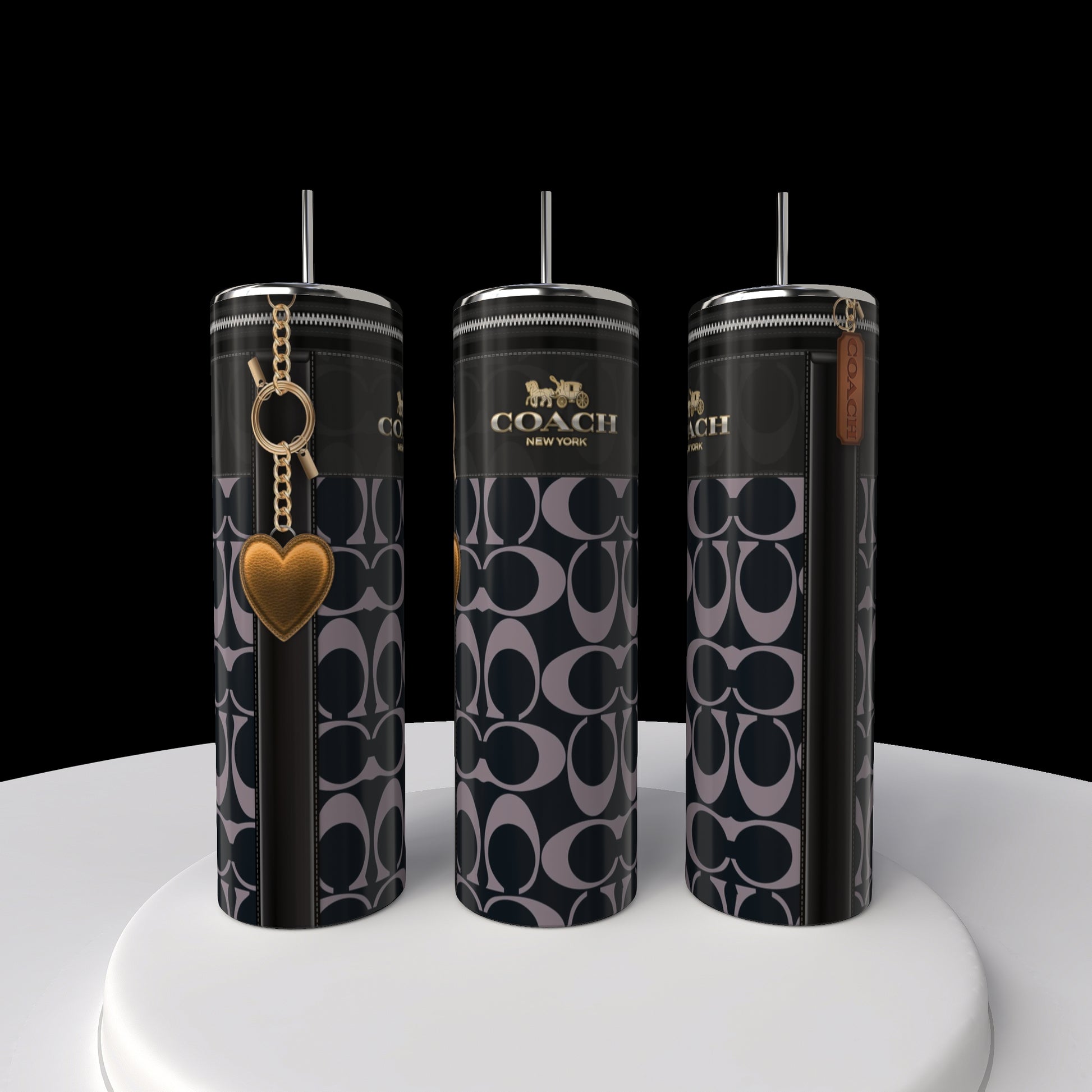 Three tall 20oz Coach Skinny Tumblers from Kreative Kreationz, featuring a black and gray pattern. Two have a heart charm and Coach tag. These stainless steel tumblers are elegantly displayed on a white circular platform against a black backdrop.